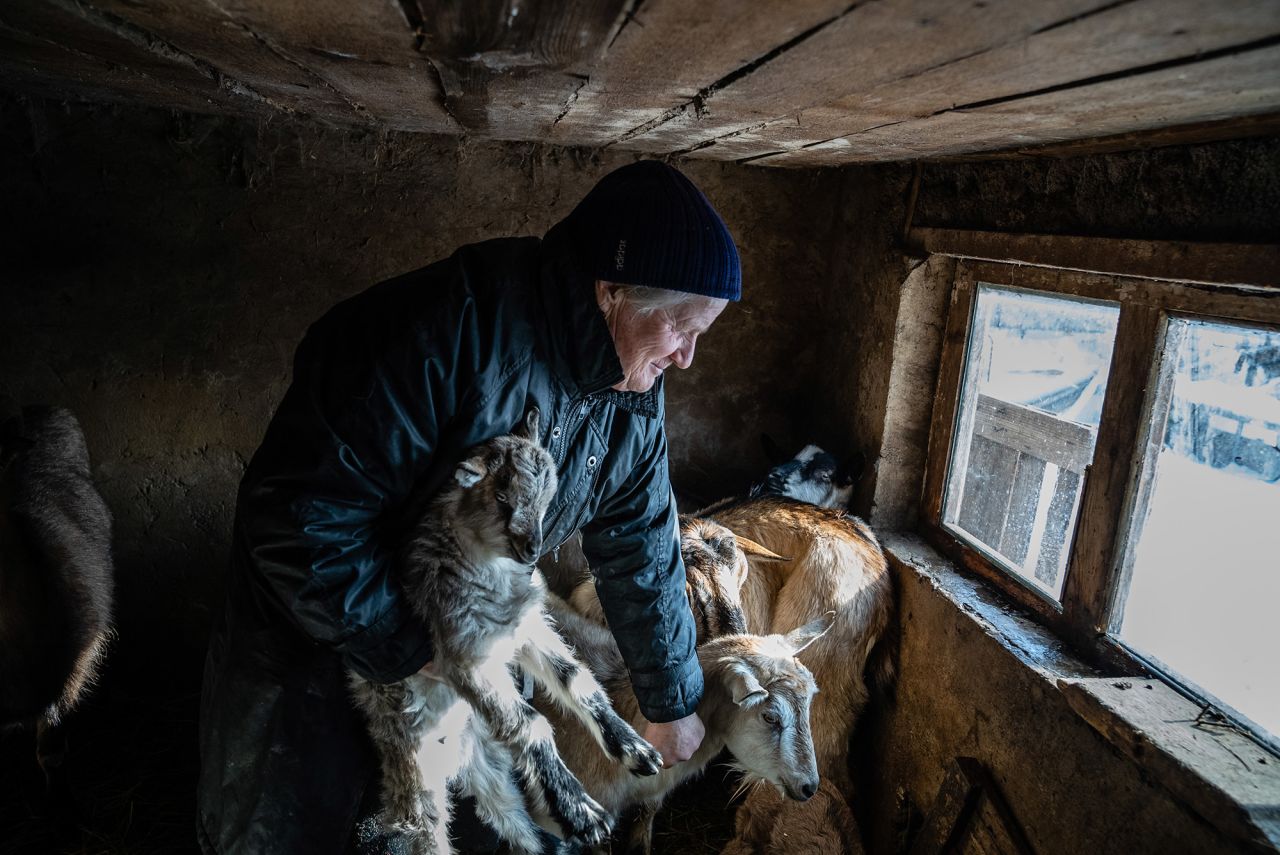 Zoya Kralya tends to her goats in Vodyane, Ukraine, on Thursday, January 27. Kralya, 66, is one of the last remaining residents of Vodyane, a tiny hamlet in the Donetsk area. Ever since her husband died a few years ago, she has lived alone and tends to her goats and a number of dogs and cats. "If there is war, I will shelter in the basement, stocked with food and water in case I have to be underground for weeks," <a href="http://www.cnn.com/2022/01/21/europe/gallery/ukraine-russia-fadek/index.html" target="_blank">she told photographer Timothy Fadek.</a> "The conflict in 2014 and 2015 was the worst thing I experienced in my life. I don't want to live through it again."