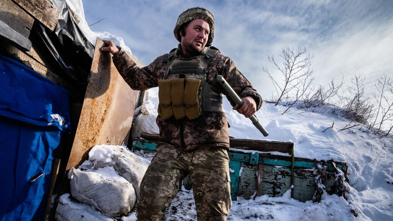 A member of the Ukrainian military climbs down from a lookout point in a defensive front line position on Thursday, January 27, 2022, near Shyrokyne, Ukraine. Photograph by Timothy Fadek/Redux