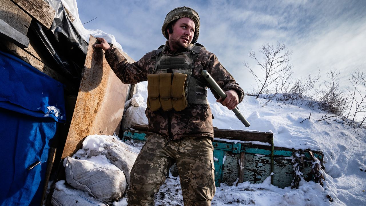 A member of the Ukrainian military holds a periscope as he climbs down from a lookout point near Shyrokyne, Ukraine.