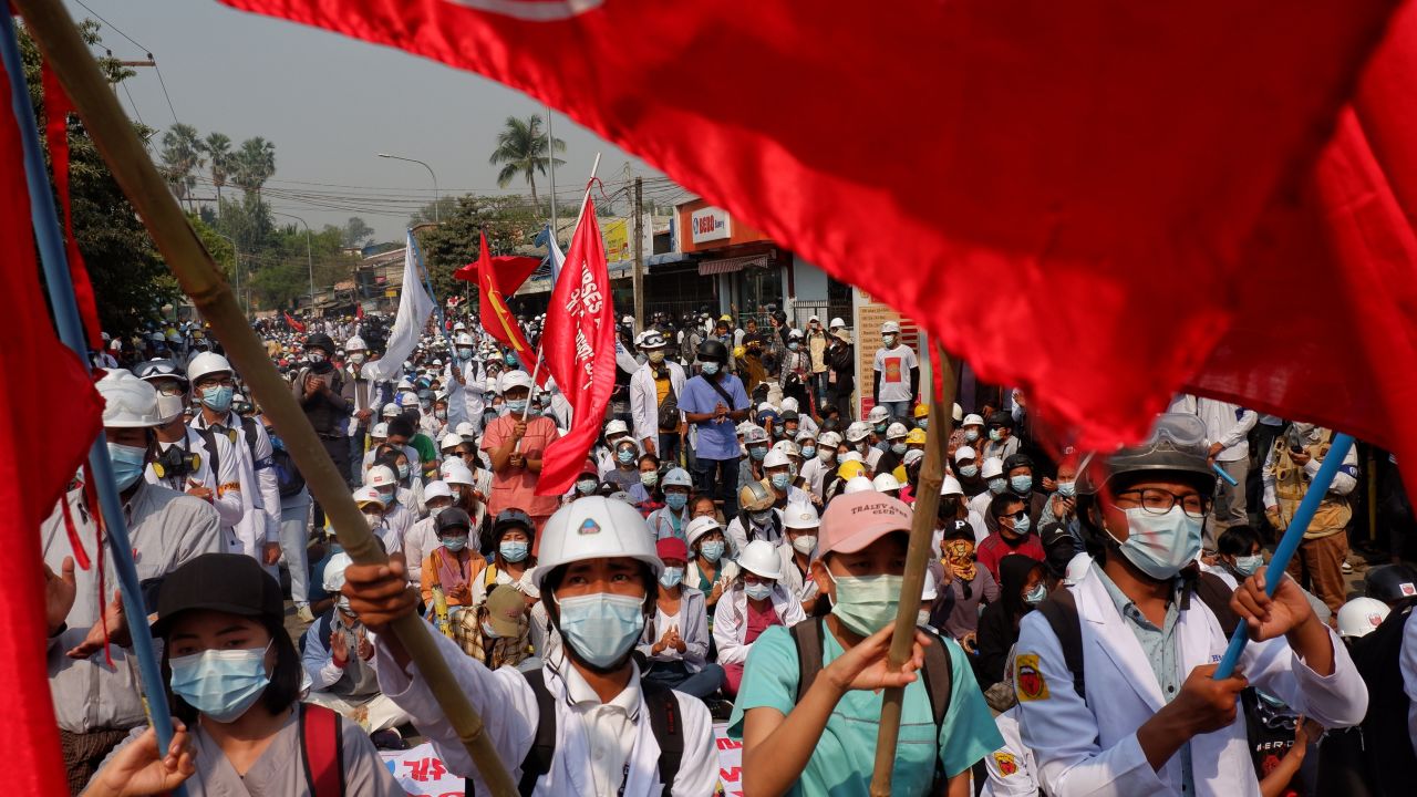 People protest against the military coup and detention of elected government members in Mandalay on March 13, 2021. 