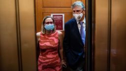 Sen. Kyrsten Sinema (D-AZ) and Sen. Joe Manchin (D-WV) catch and an elevator to go to the Senate Chamber to vote, after meeting in Sen. Manchins hideaway for half an hour, in the U.S. Capitol on Thursday, Sept. 30, 2021 in Washington, DC.  