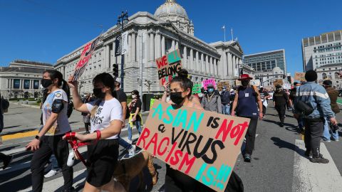 Demonstrators hold up signs as they take part in an anti-Asian American hate march and rally at San Francisco City Hall in San Francisco last year. 