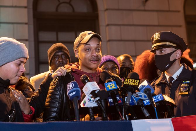 A fellow officer can't hold back his tears as he speaks at the vigil on January 26.