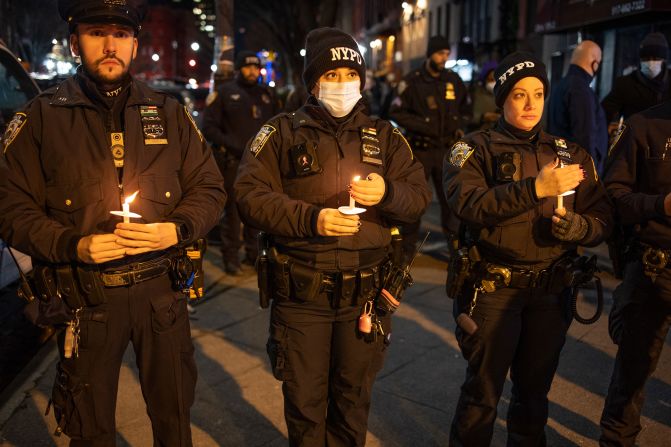 Police officers attend the vigil on January 26.