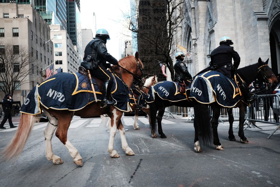 Police officers on horseback arrive outside St. Patrick's Cathedral.