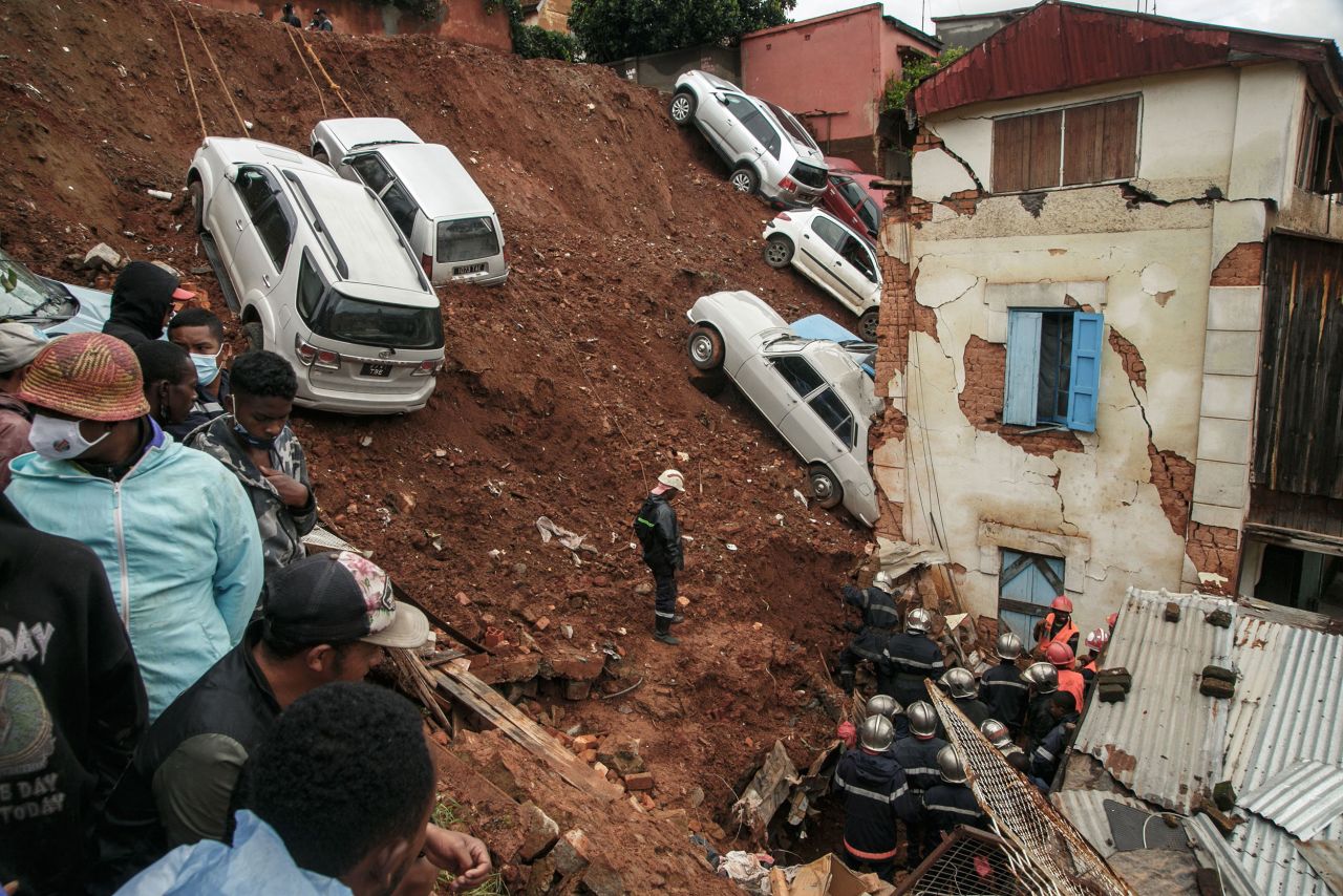 Firefighters search through debris after a car park collapsed onto houses in Antananarivo, Madagascar, on Monday, January 24. Several bodies were found after the landslide. The country had been experiencing heavy rains brought by tropical storms.