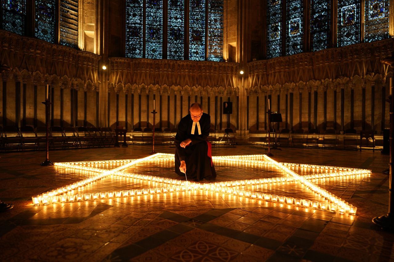 The Rev. Canon Michael Smith lights candles in York, England, on Wednesday, January 26. It was in preparation for Holocaust Memorial Day.