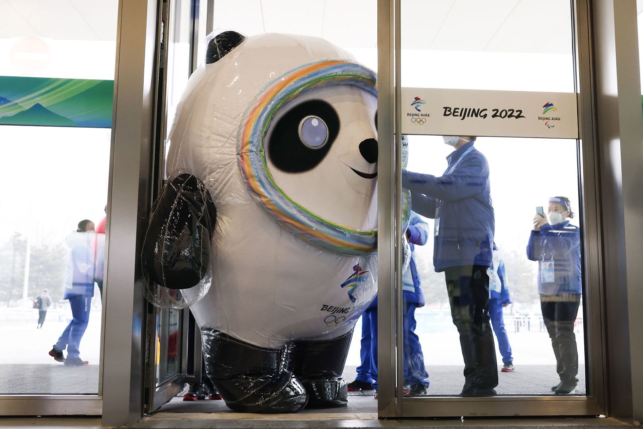 Bing Dwen Dwen, the mascot of the <a href="https://www.cnn.com/2022/01/17/sport/winter-olympics-explainer-beijing-2022-spt-intl/index.html" target="_blank">Beijing Winter Olympics,</a> tries to enter a door at the main media center on Monday, January 24. The Olympics begin next week with the opening ceremony taking place on February 4.