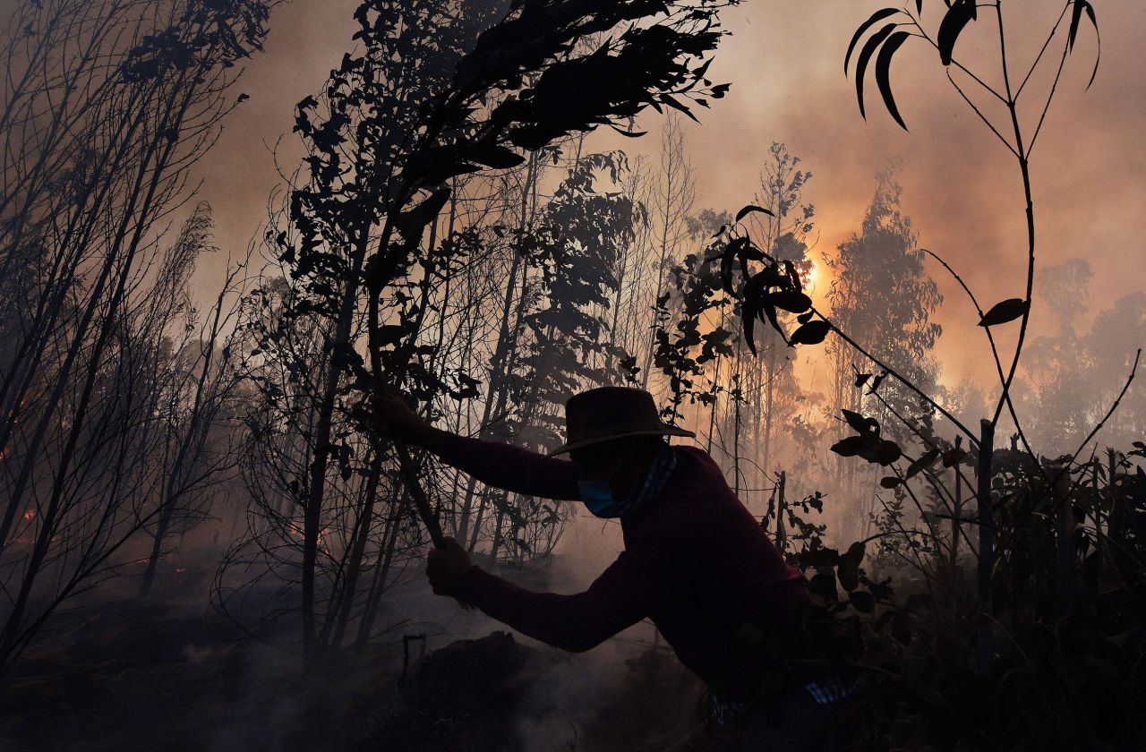 A farmer fights a bushfire in Guatavita, Colombia, on Saturday, January 22.