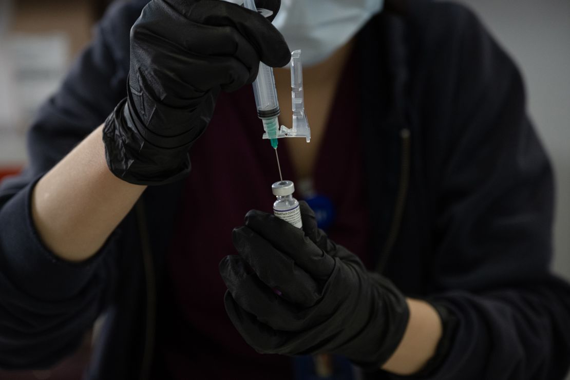 A healthcare worker prepares a Covid-19 vaccine at a Southern Nevada Health District testing site in Las Vegas, Nevada, on January 6, 2022.