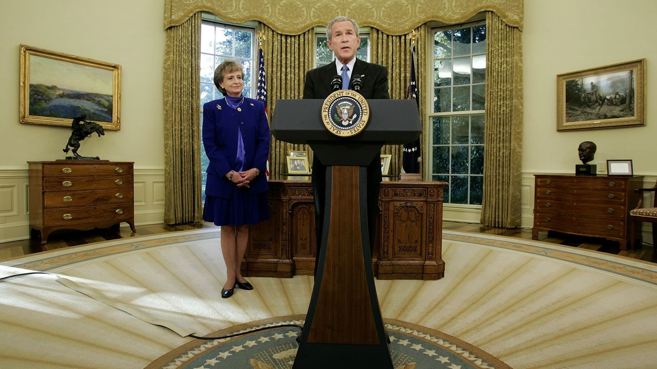 Supreme Court nominee, Harriet Miers listens as President George W. Bush speaks in the Oval Office of the White House October 3, 2005 in Washington.  