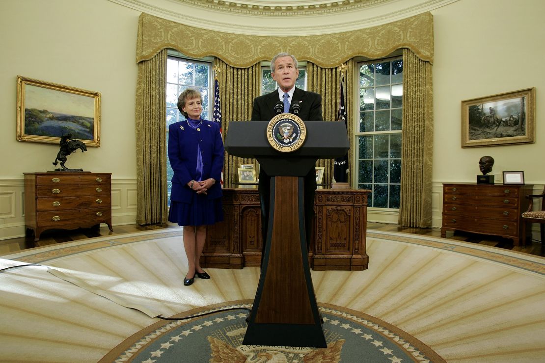 Supreme Court nominee, Harriet Miers listens as President George W. Bush speaks in the Oval Office of the White House October 3, 2005 in Washington.  