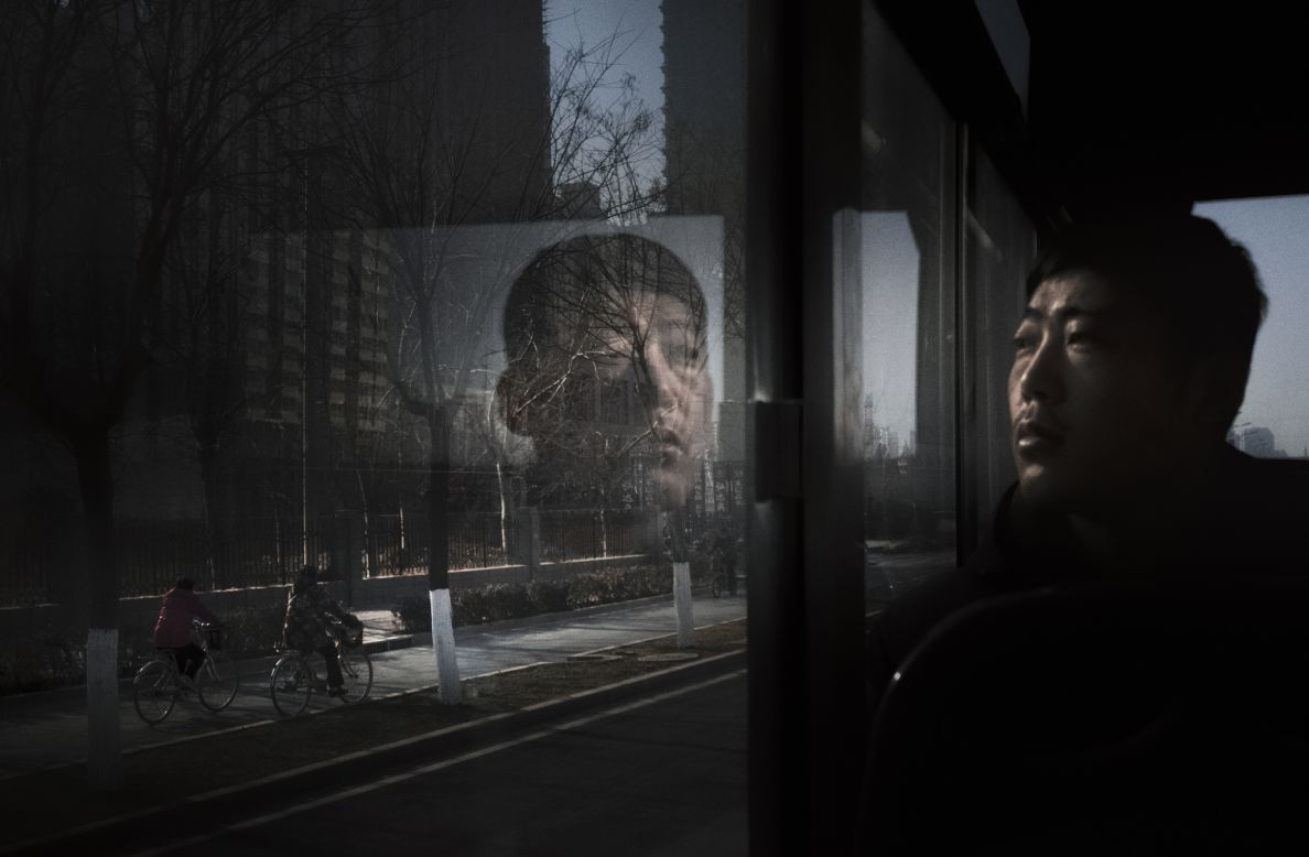In Polish photographer Arek Rataj's image "116," a man stares out of a bus window in Shijiazhuang, Hebei province. 