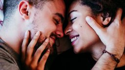 happy couple in love at home. Afro american woman and caucasian man. ethnic love concept