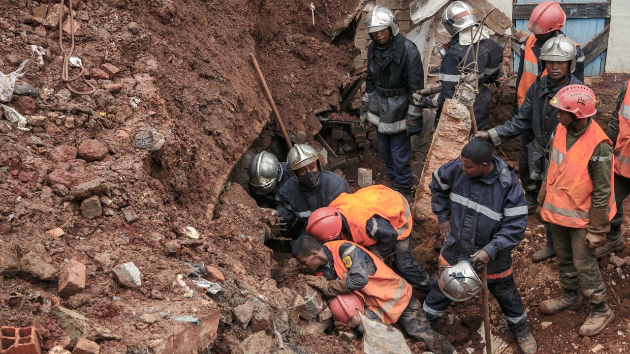 Firefighters search through rubble after a housing carpark collapsed on houses following heavy rains in Madagascar. 