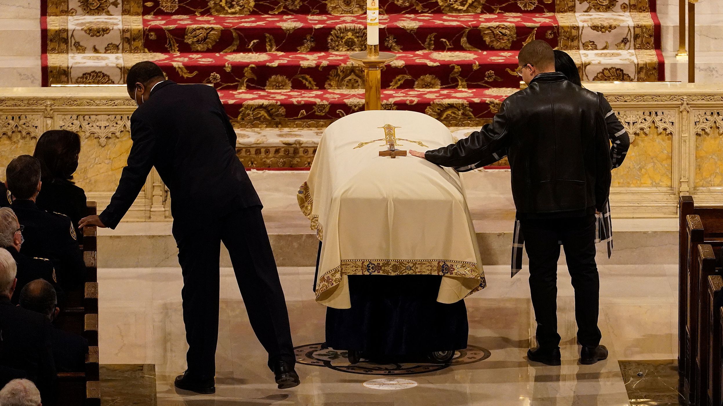 Family members touch Rivera's casket during his funeral.