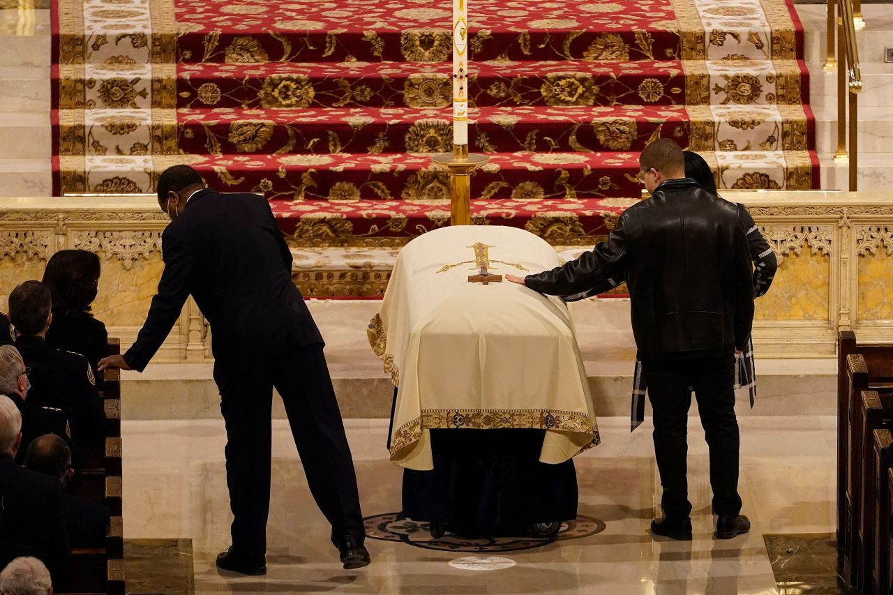 Family members touch Rivera's casket during his funeral.