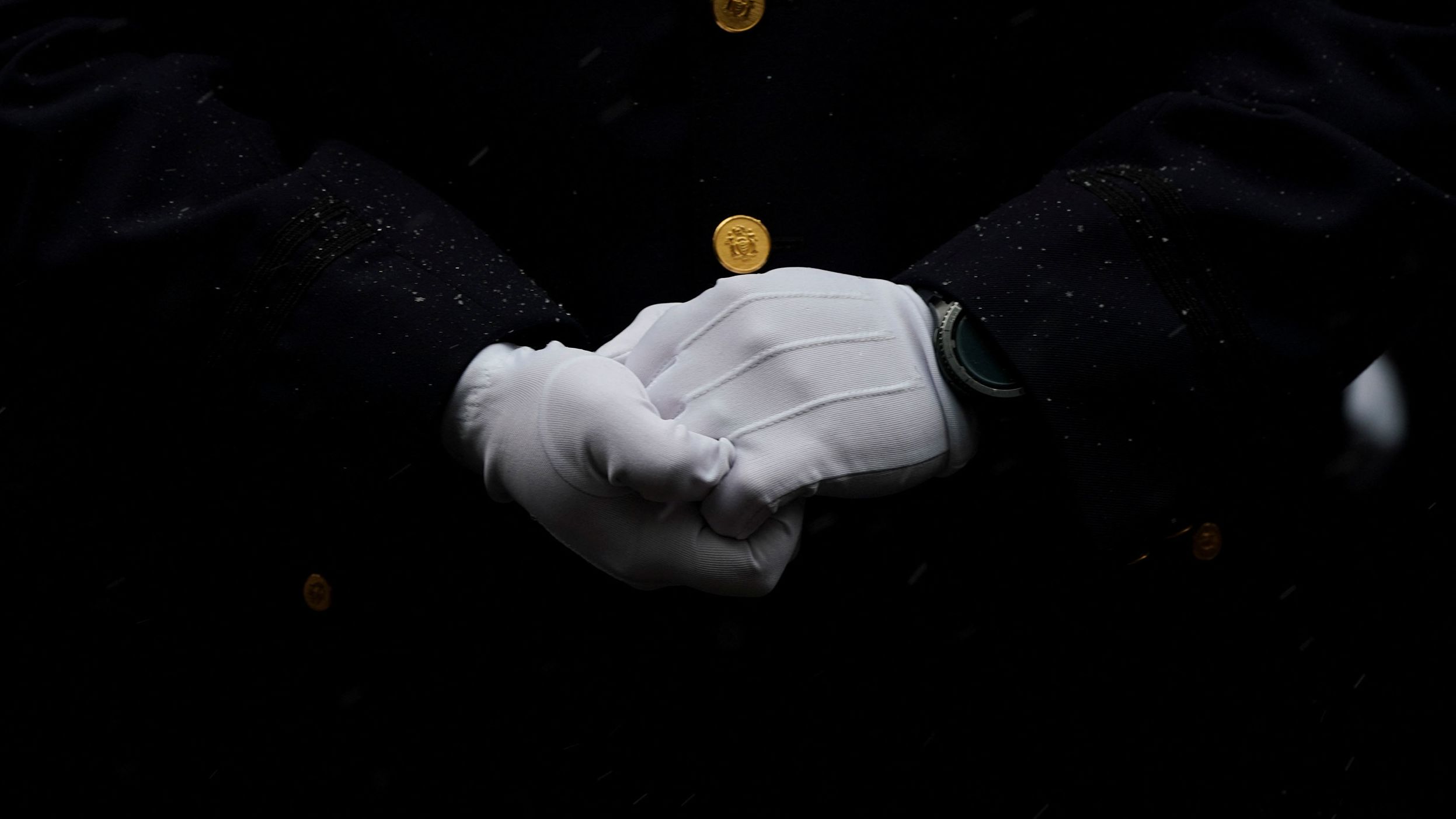 A member of the NYPD attends Rivera's funeral.