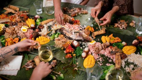 Ling enjoys a Filipino kamayan feast in the first episode of her series, "Take Out With Lisa Ling.