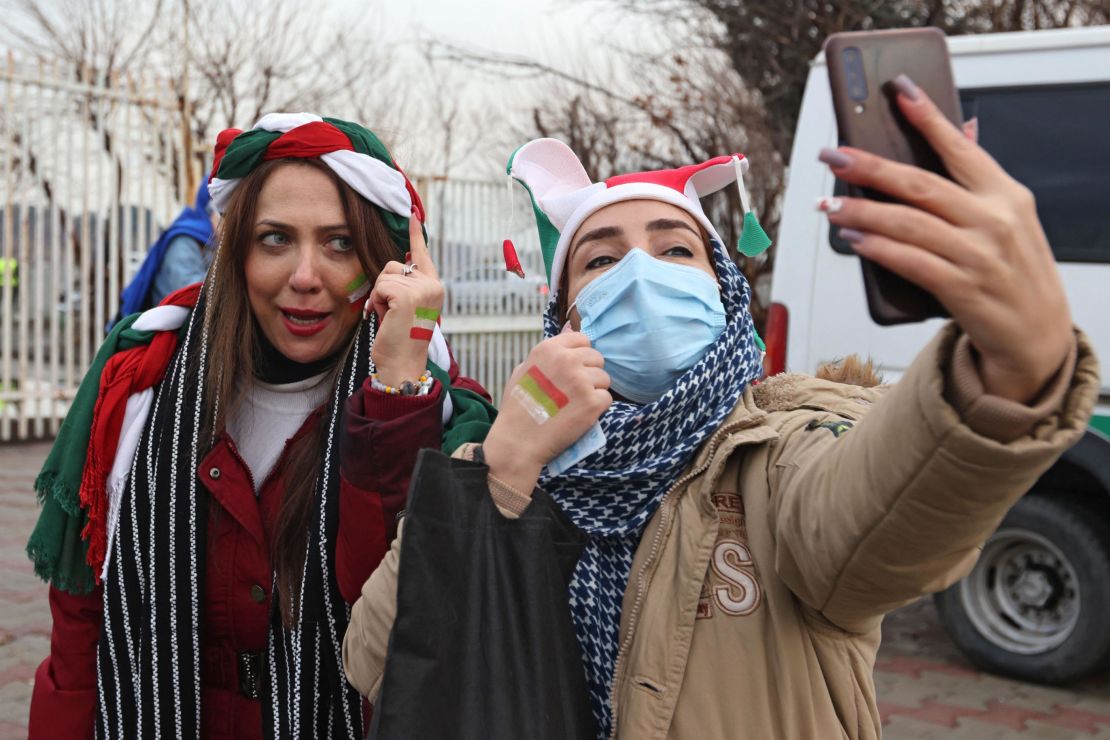 Iranian fans pose for a selfie ahead of the 2022 Qatar World Cup Asian Qualifiers match between Iran and Iraq.