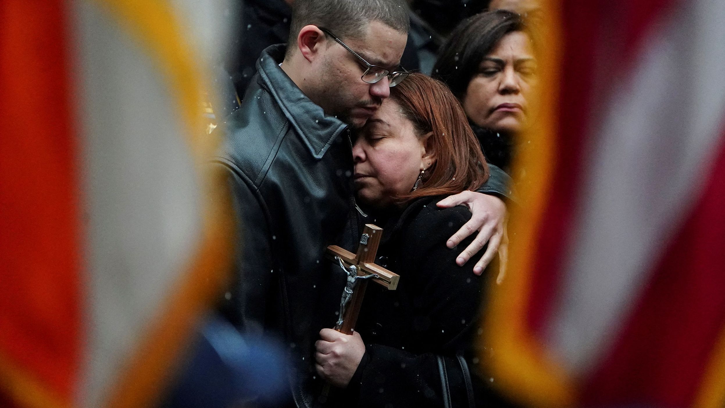 The mother of Officer Jason Rivera is comforted during Rivera's funeral service on Friday, January 28.