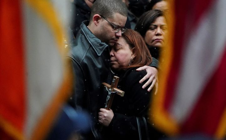 The mother of Officer Jason Rivera is comforted during Rivera's funeral service on Friday, January 28.