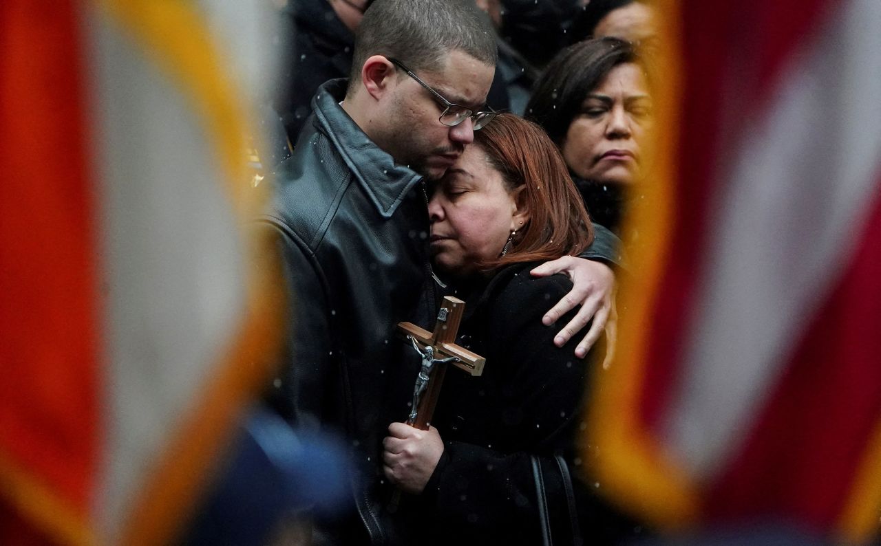 The mother of New York police officer Jason Rivera is comforted during Rivera's funeral service on Friday, January 28. Rivera and his partner, Wilbert Mora, were fatally shot last month as they responded to a domestic disturbance call. Thousands of New York police officers <a href="http://www.cnn.com/2022/01/27/us/gallery/nypd-officer-memorials/index.html" target="_blank">attended their funerals.</a>