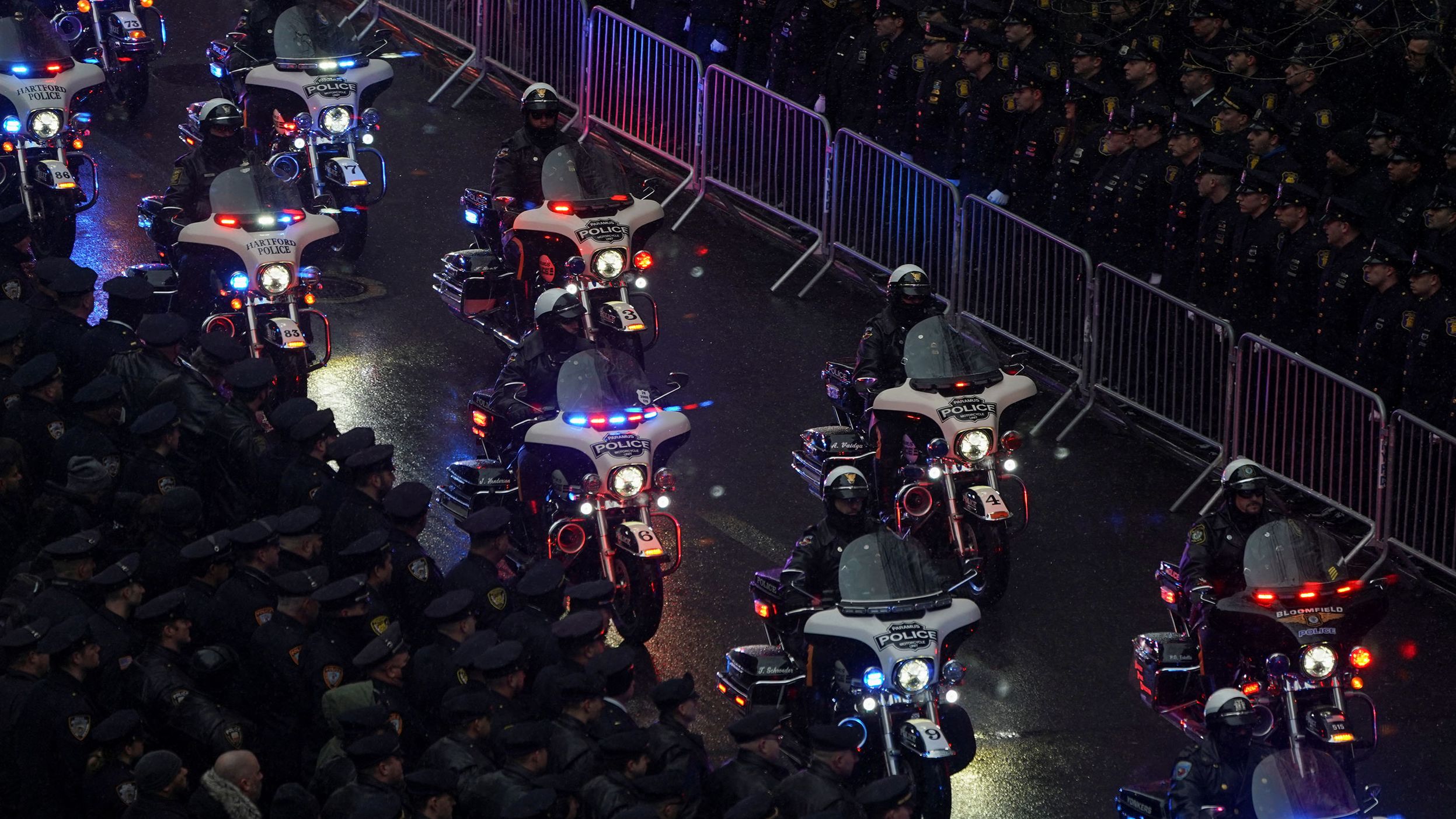 Police officers on motorcycles accompany Rivera's hearse.