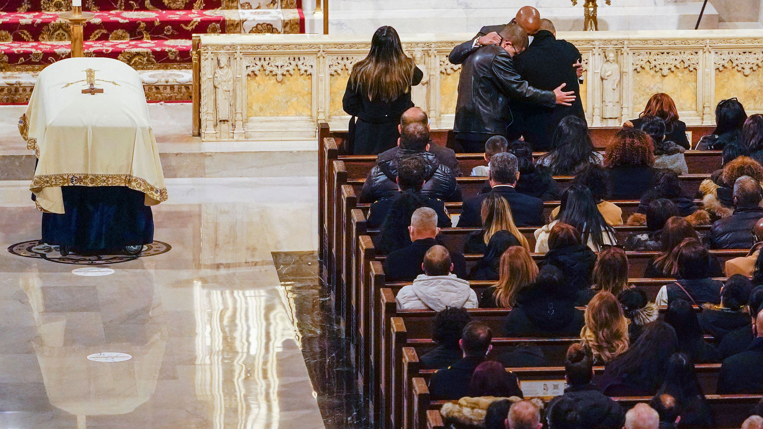 New York City Mayor Eric Adams hugs members of Rivera's family at his funeral. "We as a city, as a state, and as a nation — we say thank you, Jason. Today our hearts are with his beautiful family," Adams said at the service. "He's a hero, and our fellow New Yorkers acknowledge that."