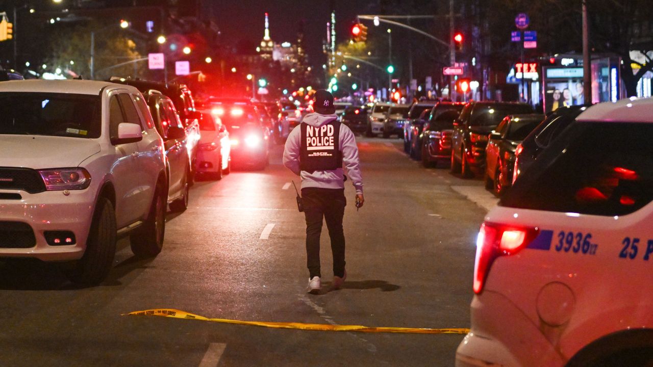 Police at the scene after two NYPD officers were shot in Harlem on January 21, 2022. The gun used to kill the officers was stolen in Baltimore five years ago, according to authorities.