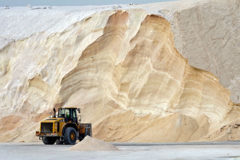 A bulldozer sits in front of a mountain of salt that will be used to treat roads and highways in Chelsea, Massachusetts, on Friday. 