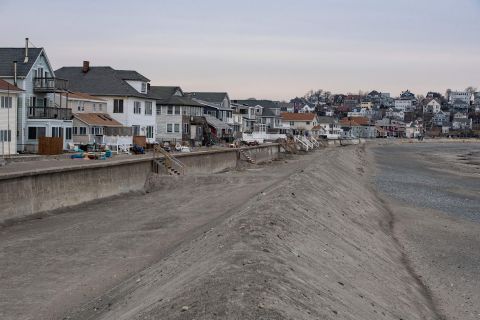 A sand brim wall is put up to protect beach homes from storm waves in Winthrop, Massachusetts on Friday, January 28.