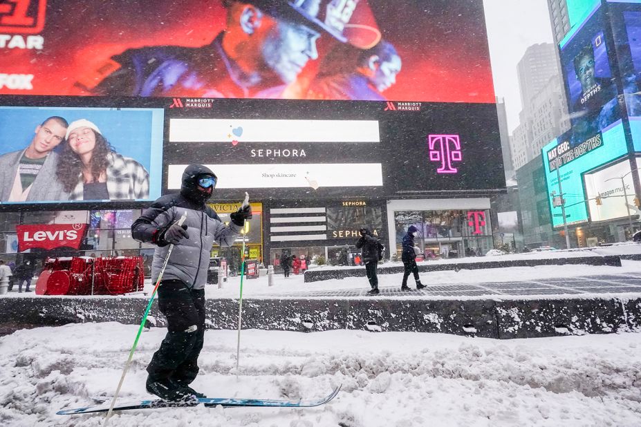 A person cross country skis through New York's Times Square during a snow storm on Saturday.