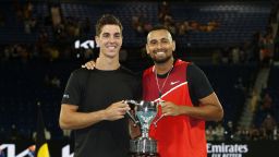 MELBOURNE, AUSTRALIA - JANUARY 29: Thanasi Kokkinakis (L) of Australia and Nick Kyrgios of Australia pose with the championship trophy after winning their Men's Doubles Final match against Matthew Ebden of Australia and Max Purcell of Australia during day 13 of the 2022 Australian Open at Melbourne Park on January 29, 2022 in Melbourne, Australia. (Photo by Darrian Traynor/Getty Images)