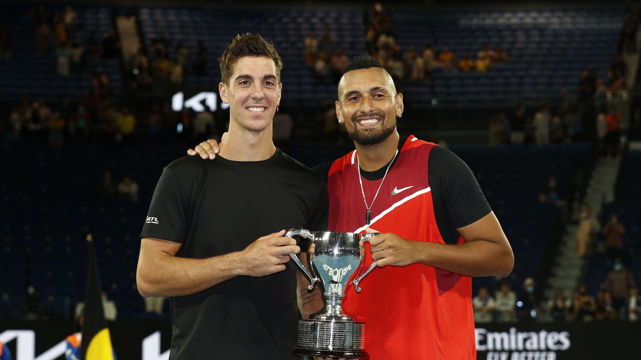 Thanasi Kokkinakis and Nick Kyrgios pose with the championship trophy after winning their men's doubles final.