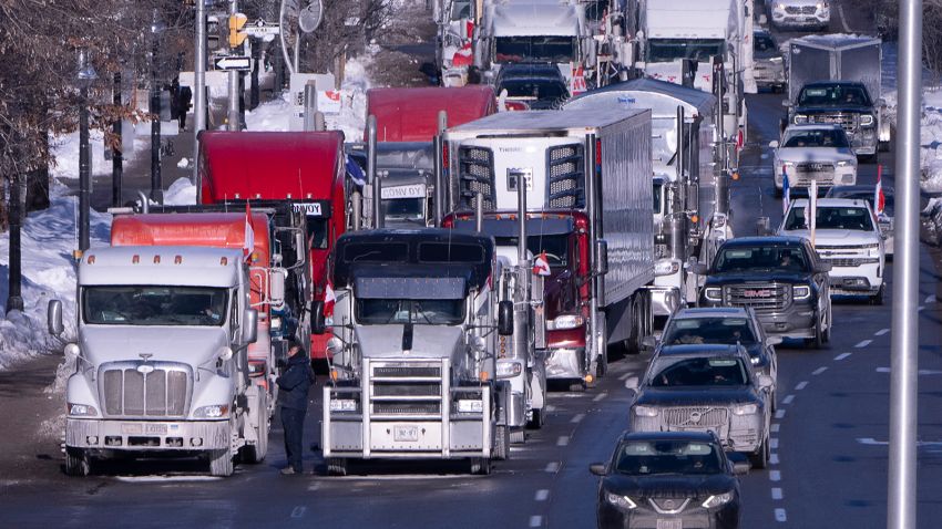 Vehicles from the protest convoy are parked blocking lanes on a road, Sunday, Jan. 30, 2022 in Ottawa. Residents of the national capital are again being told to avoid traveling downtown as a convoy of trucks and cars snarl traffic protesting government-imposed vaccine mandates and COVID-19 restrictions. (Adrian Wyld/The Canadian Press via AP)