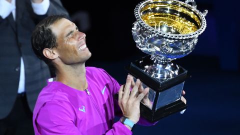 Rafael Nadal lifts a historic 21st grand slam trophy.