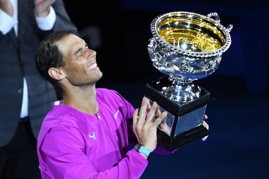 Rafael Nadal lifts a historic 21st grand slam trophy.