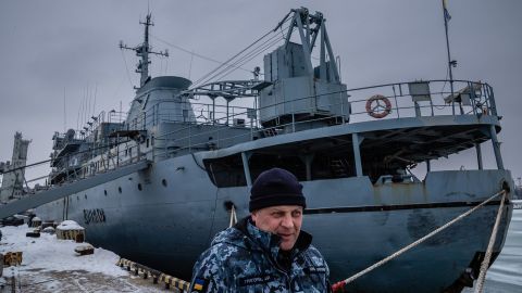 Ukranian Navy Capt. Oleksandr Hrigorevskiy stands on the dock of Mariupol's port with his ship, the Donbas, behind him.