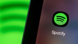 The Spotify app logo seen on the screen of a smartphone.