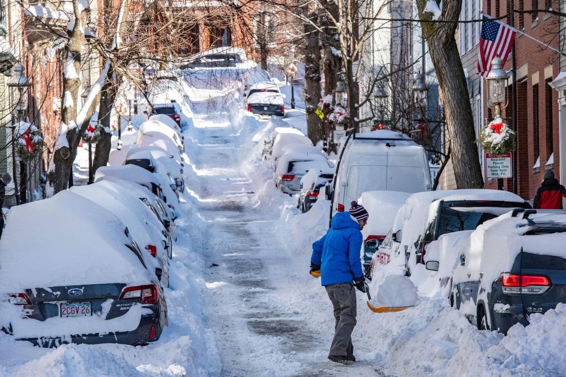Someone shovels snow Sunday in Boston.