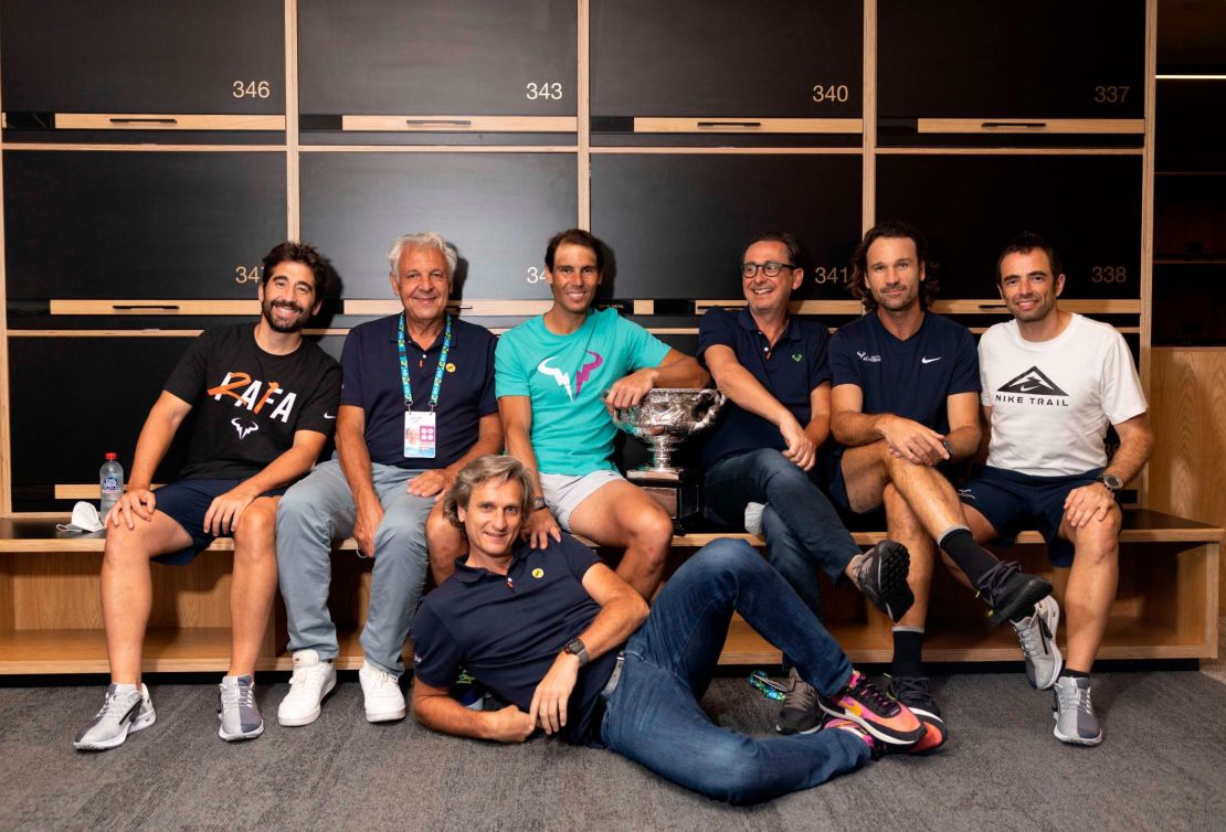 Nadal poses with the Australian Open men's singles final trophy in the locker room.