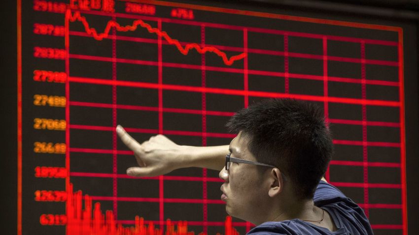 BEIJING, CHINA - AUGUST 27: A Chinese day trader reacts as he watches a stock ticker at a local brokerage house on August 27, 2015 in Beijing, China. A dramatic sell-off in Chinese stocks caused turmoil in markets around the world, driving indexes lower and erasing trillions of dollars in value. China's government has implemented a series of top-heavy measures to manipulate a market turnaround including its fifth cut to interest rates since November. Concerns about the overall health of China's economy remain amid data showing slower growth. (Photo by Kevin Frayer/Getty Images)
