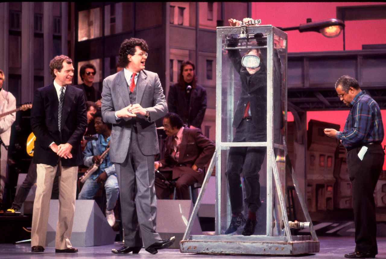 Letterman and magician Penn Jillette watch Teller perform a card trick inside a water tank in 1989.