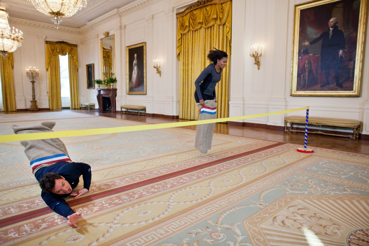 Fallon and first lady Michelle Obama participate in a potato sack race in the White House in 2012.