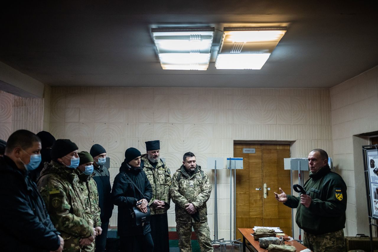New reservists listen to instruction at an unused school building in Kharkiv.