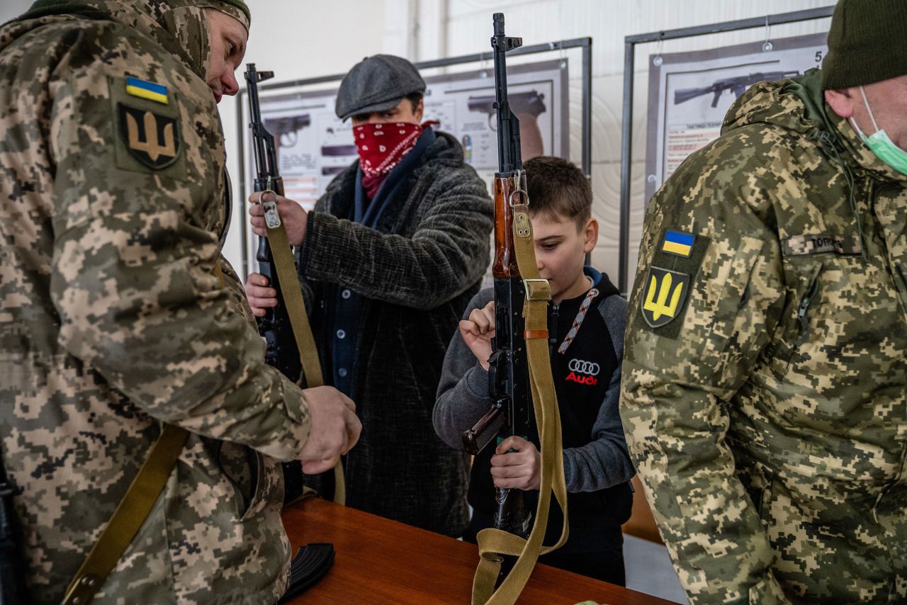 A child is among local civilians who were given instruction on how to disassemble AK-47 rifles in Kharkiv, Ukraine, on Saturday, January 29. Soldiers were also <a href="https://www.cnn.com/2022/02/01/europe/gallery/ukraine-russia-training-fadek/index.html" target="_blank">training new reservists there.</a>