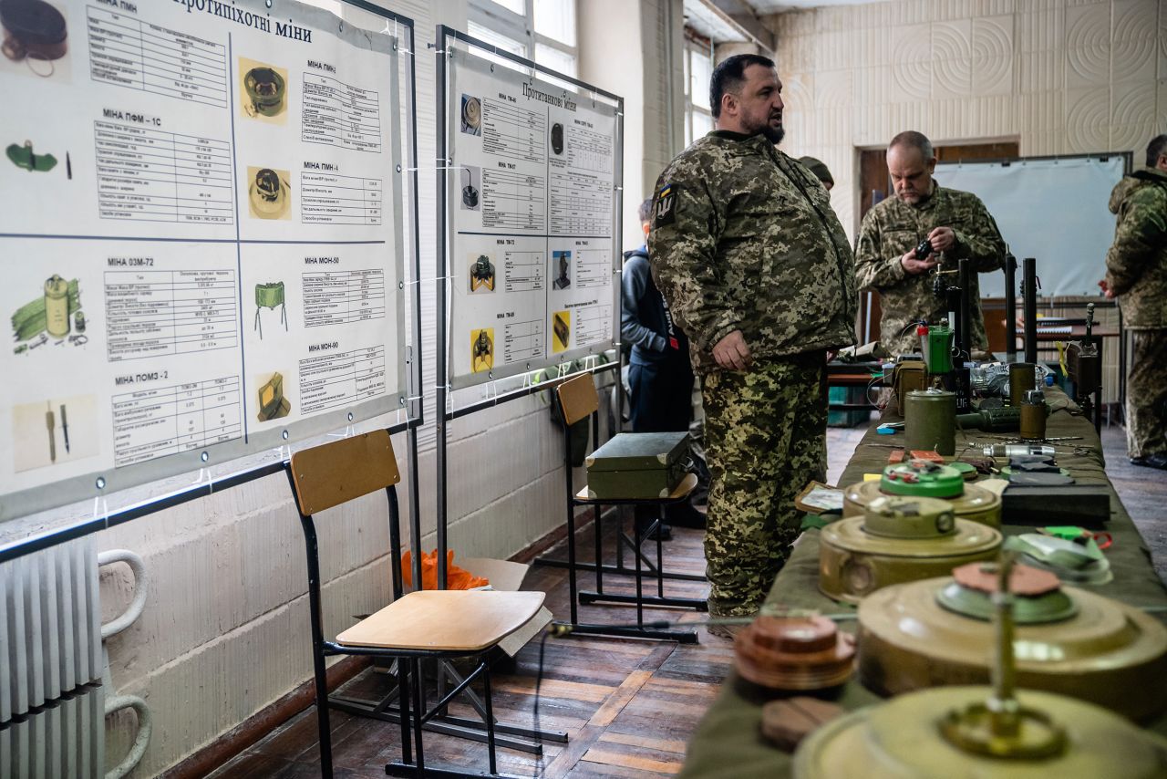 A soldier instructs new reservists on how to identify mines, grenades and other explosive devices. "One of the trainers surprised everyone by detonating a detonation cap, which is like a large firecracker," Fadek said. "It's used to detonate a larger explosive. My ears are still ringing."