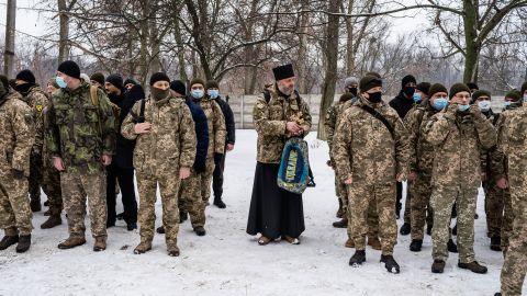 An Orthodox priest attends the reservists' first day of training in Kharkiv.