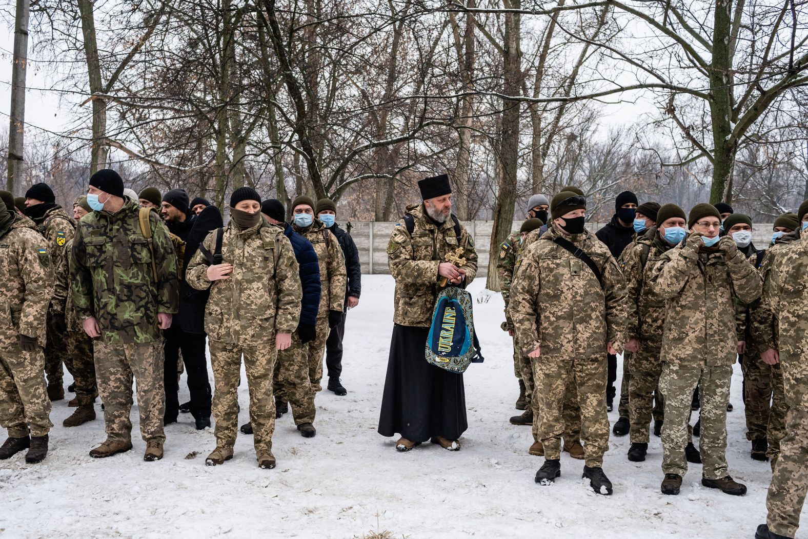 An Orthodox priest attends the reservists' first day of training in Kharkiv.